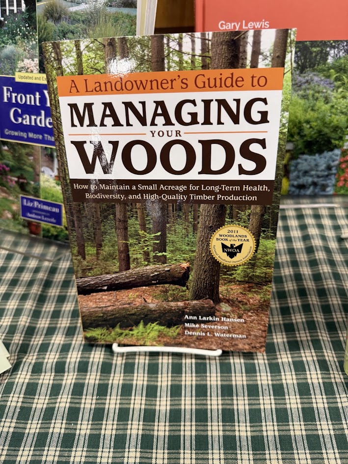 A copy of A Landowner's Guide to Managing Your Woods displayed on a table
